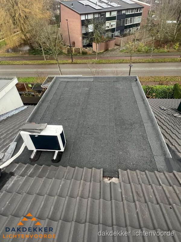 Plat dak inspectie met bitumen bedekking naast schuin pannendak in Lichtenvoorde Plat dak inspectie met bitumen bedekking naast schuin pannendak in Lichtenvoorde